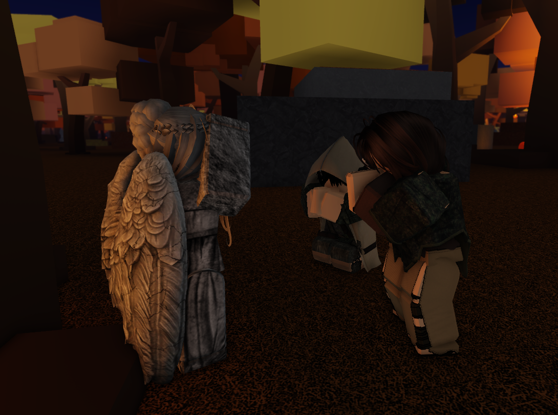 Two individuals, a kneeling man, and a standing woman, praying to what appears to be a stone statue of an angel, sitting in front of a tree.